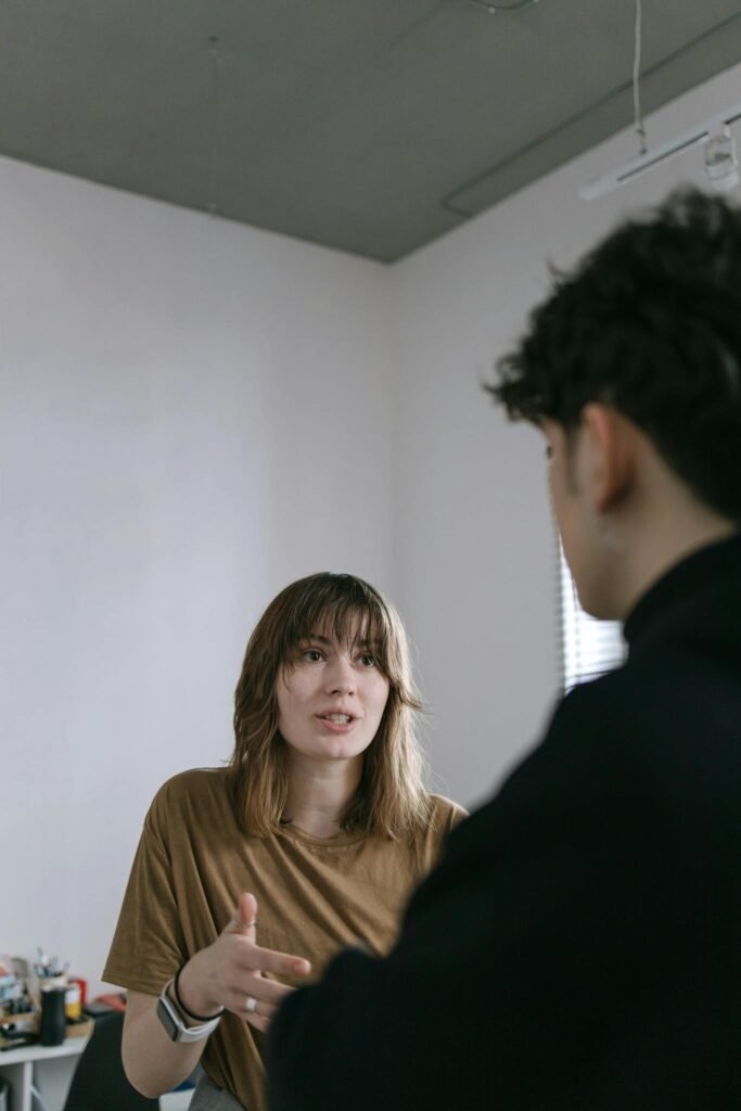 Young professionals in a lively discussion at a modern office setting.